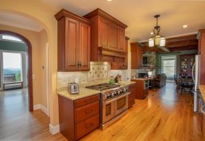 a kitchen with wooden cabinets and a stove top oven at The Retreat at Mountain Meadows in Banner Elk