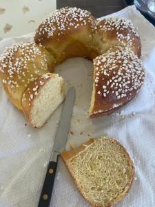 a piece of bread and a knife on a table at 15 min from Lyon Fresh Peaceful Room with Pool and Garden in Dardilly