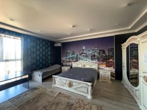 a bedroom with two beds and a city mural at Dan plus in Aktobe