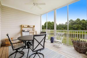 a patio with a table and chairs on a balcony at Bear Trap Dunes - 56E October Glory in Ocean View