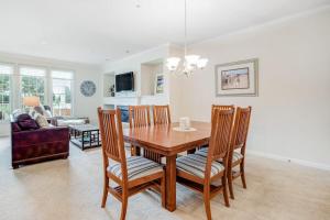 a dining room and living room with a table and chairs at Bear Trap Dunes - 56E October Glory in Ocean View +32 photos