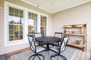 a patio with a table and chairs on a porch at Bear Trap Dunes - 56E October Glory in Ocean View