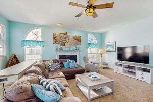 a living room with a couch and a flat screen tv at Wedgefield -- 1 Wedgefield in Ocean View