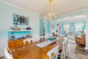 a dining room and living room with a table and chairs at Wedgefield -- 1 Wedgefield in Ocean View