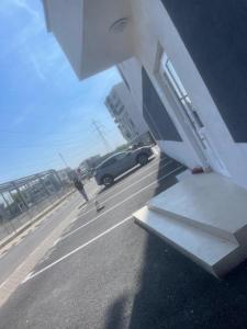 a car is driving down a road with aphalt at Apartment complex in Roşu