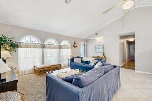 a living room with two blue couches at Candlelight Acres - 530 Candlelight in Bethany Beach