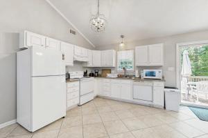 a kitchen with white appliances and a large window at Candlelight Acres - 530 Candlelight in Bethany Beach +14 photos
