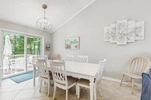 a dining room with a white table and chairs at Candlelight Acres - 530 Candlelight in Bethany Beach
