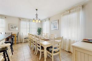 a kitchen and dining room with a table and chairs at Bayside Resort - 36398 Azalea Ave in Selbyville
