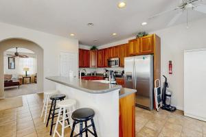 a kitchen with a counter and some stools in it at Bayside Resort - 36398 Azalea Ave in Selbyville