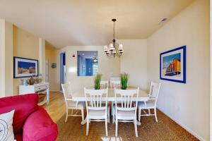 a dining room with a table and chairs at Bear Trap Dunes - 214H October Glory Ave in Ocean View
