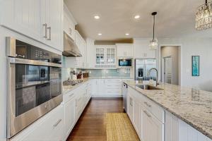 a kitchen with white cabinets and stainless steel appliances at Marlin Chase --- 30347 Bermuda Dr in Ocean View +21 photos