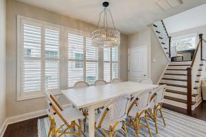 a dining room with a table and chairs and a chandelier at Marlin Chase --- 30347 Bermuda Dr in Ocean View