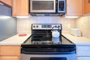 a tea kettle is sitting on a stove in a kitchen at Sunspot Condo --- 2 McKinley Ave, Unit 103 in Dewey Beach