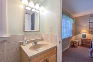 a bathroom with a sink and a mirror at Sunspot Condo --- 2 McKinley Ave, Unit 103 in Dewey Beach +9 photos