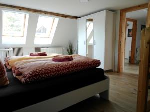 a bedroom with a bed in a room with windows at Ferienhaus Fichtelberg in Kurort Oberwiesenthal