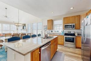 a kitchen with wooden cabinets and stainless steel appliances at Bear Trap Dunes - 81 Tulip Poplar in Ocean View +41 photos