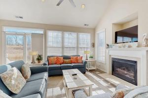 a living room with a couch and a fireplace at Bear Trap Dunes - 81 Tulip Poplar in Ocean View