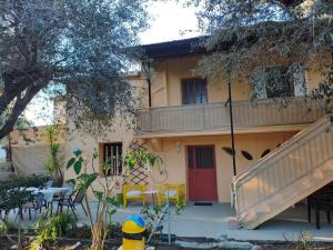a house with a balcony and a table and chairs at Petrohori before midnight in Pylos +51 photos