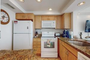a kitchen with a white refrigerator and a sink at Sea Colony - 702 Dover House Rd. in Bethany Beach