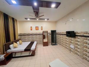a bedroom with a bed and a ceiling fan at Hotel CHINTPURNI JMC in Bharwain
