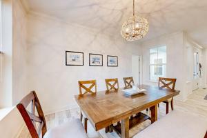 a dining room with a wooden table and chairs at The Estuary - 26643 Weathervane Way in Frankford