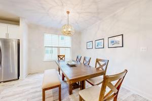 a dining room with a table and a refrigerator at The Estuary - 26643 Weathervane Way in Frankford