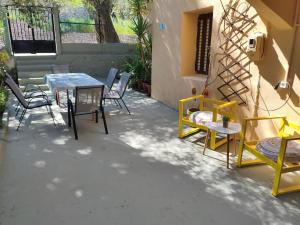 a table and chairs sitting on a patio at Petrohori before midnight in Pylos