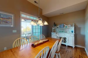 a dining room with a wooden table and chairs at Bear Trap Dunes - 126B October Glory Ave in Ocean View +40 photos