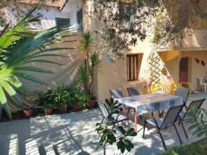 a patio with a table and chairs and plants at Petrohori before midnight in Pylos