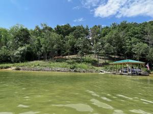 a dock with a gazebo in the middle of a lake at Lake Haven Lodge in Wilkesboro
