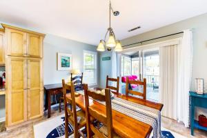 a dining room with a wooden table and chairs at Forest Reach --- 33720 Chatham Way in Frankford +18 photos