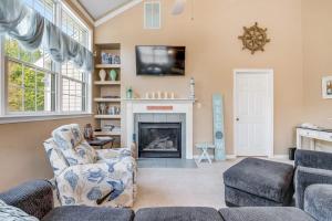 a living room with a couch and a fireplace at Bear Trap Dunes - 28 October Glory in Ocean View