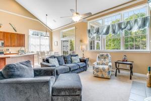 a living room with two couches and a kitchen at Bear Trap Dunes - 28 October Glory in Ocean View