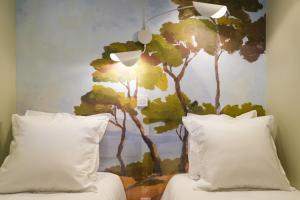 a bedroom with a mural of trees on the wall at Chiberta Ocean & Golf Suite in Anglet +21 photos