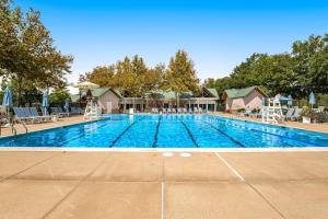a large swimming pool with chairs and umbrellas at Bear Trap Dunes - 28 October Glory in Ocean View