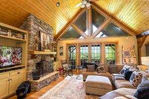 a large living room with a large stone fireplace at The Ponderosa in Boone