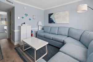 a living room with a blue couch and a table at Desert Sand Resort in Avalon