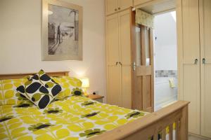 a bedroom with a bed with yellow and black pillows at 1 Bed in Mumbles oc-hh1210 in The Mumbles