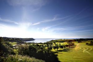 a view of a golf course with the ocean in the background at 1 Bed in Mumbles oc-hh1210 in The Mumbles