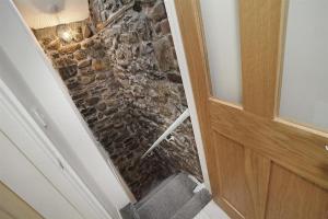 a stone wall in a room with a door at 1 Bed in Mumbles oc-hh1210 in The Mumbles +18 photos