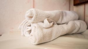 a pile of towels sitting on a bed at Villa Rodothea in Khelmáta +68 photos