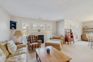 a living room with a couch and a table at Sea Colony - 55006 Pine View Rd in Bethany Beach