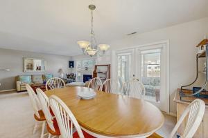 a dining room with a wooden table and chairs at Sea Colony - 55006 Pine View Rd in Bethany Beach