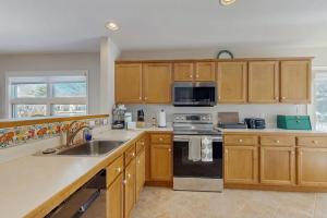 a kitchen with a sink and a stove top oven at Sea Colony - 55006 Pine View Rd in Bethany Beach