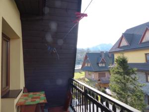 a kite on the side of a wall on a balcony at Pokoje u ZośkiP in Zakopane
