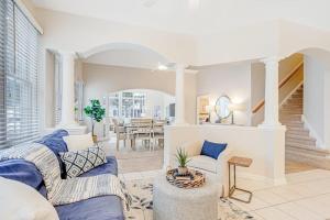a living room with a blue couch and a table at Bear Trap Dunes - 96 Willow Oak in Ocean View