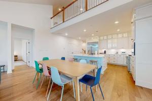 a kitchen with a wooden table and blue chairs at Marlin Chase---30453 Madeira Ln in Ocean View