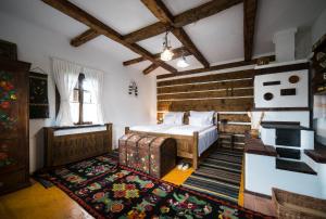 a bedroom with a bed and a rug at Pension La Roata in Gura Humorului