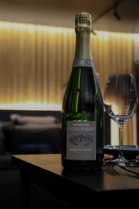 a bottle of wine sitting on a table next to a glass at Osmose Dijon in Dijon